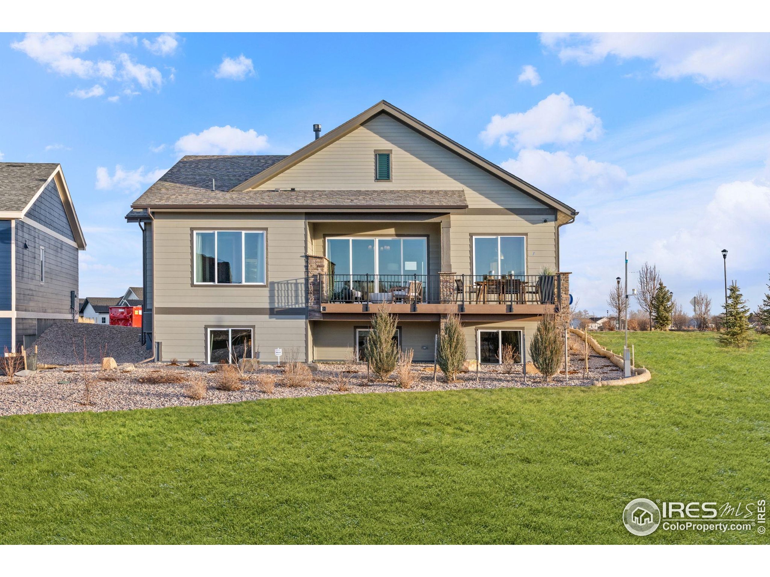 3016 Windward Way Fort Collins, CO 80524 - Photo 43 of 49 a front view of a house with garden and sitting area