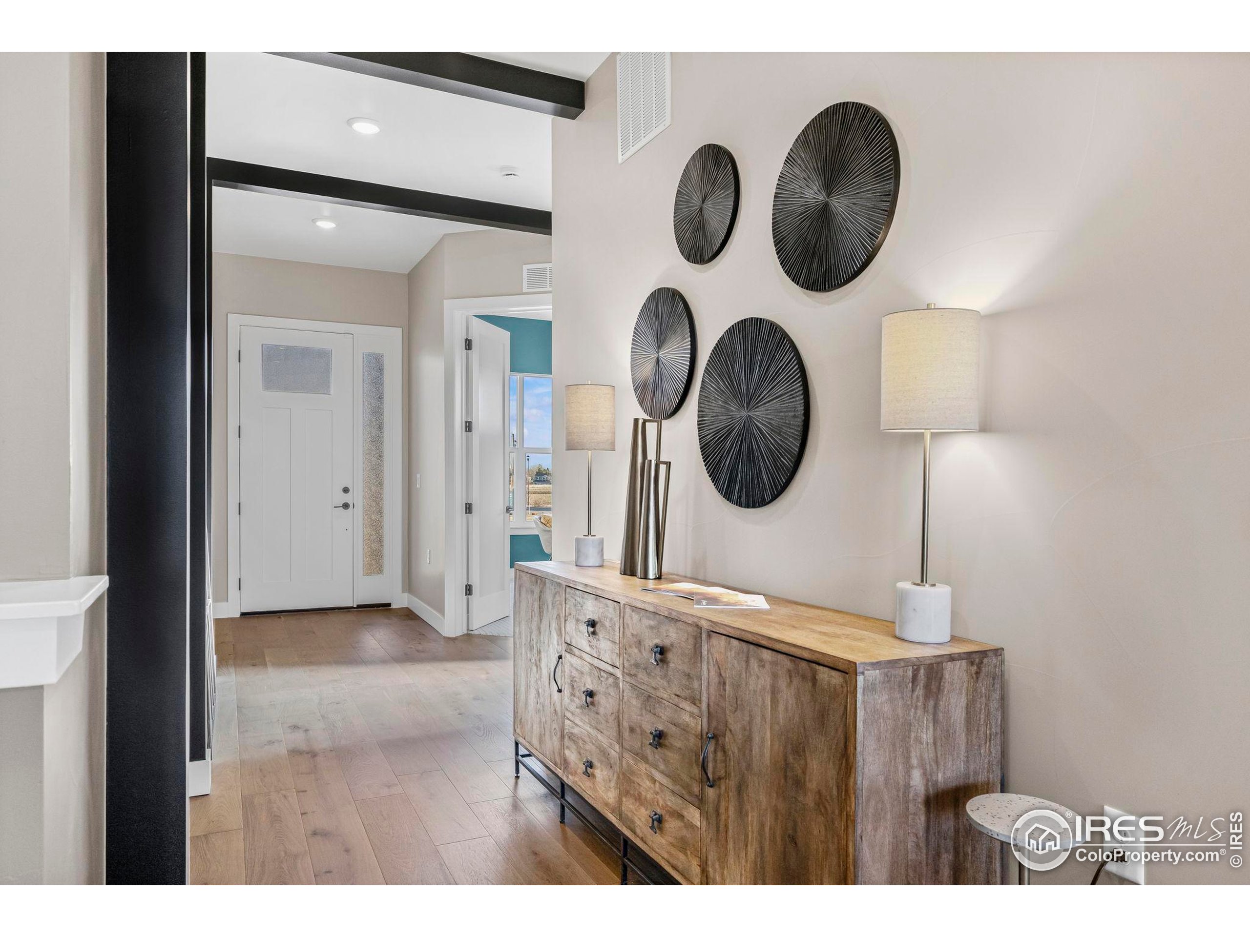 3016 Windward Way Fort Collins, CO 80524 - Photo 5 of 49 a view of a hallway with washer and a mirror
