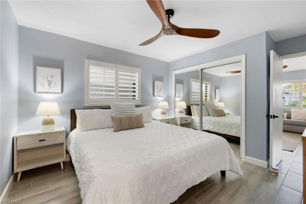 975 9th Avenue South, Unit 19 Naples, FL 34102 - Photo 12 of 19 a bedroom with a bed and a large mirror