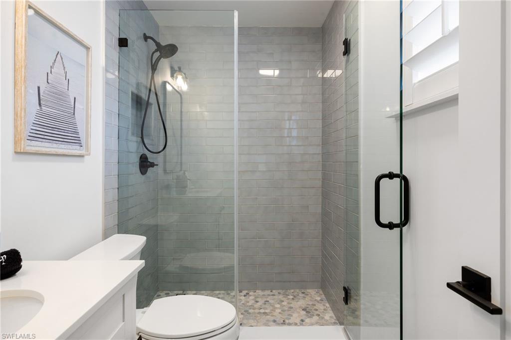 975 9th Avenue South, Unit 19 Naples, FL 34102 - Photo 14 of 19 a bathroom with a toilet and a shower