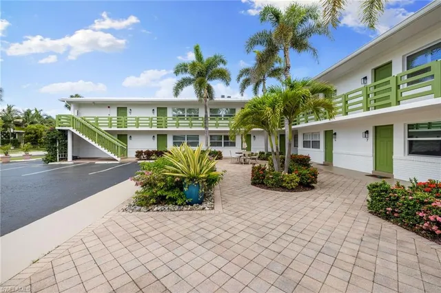 a house with beautiful flower in front of it