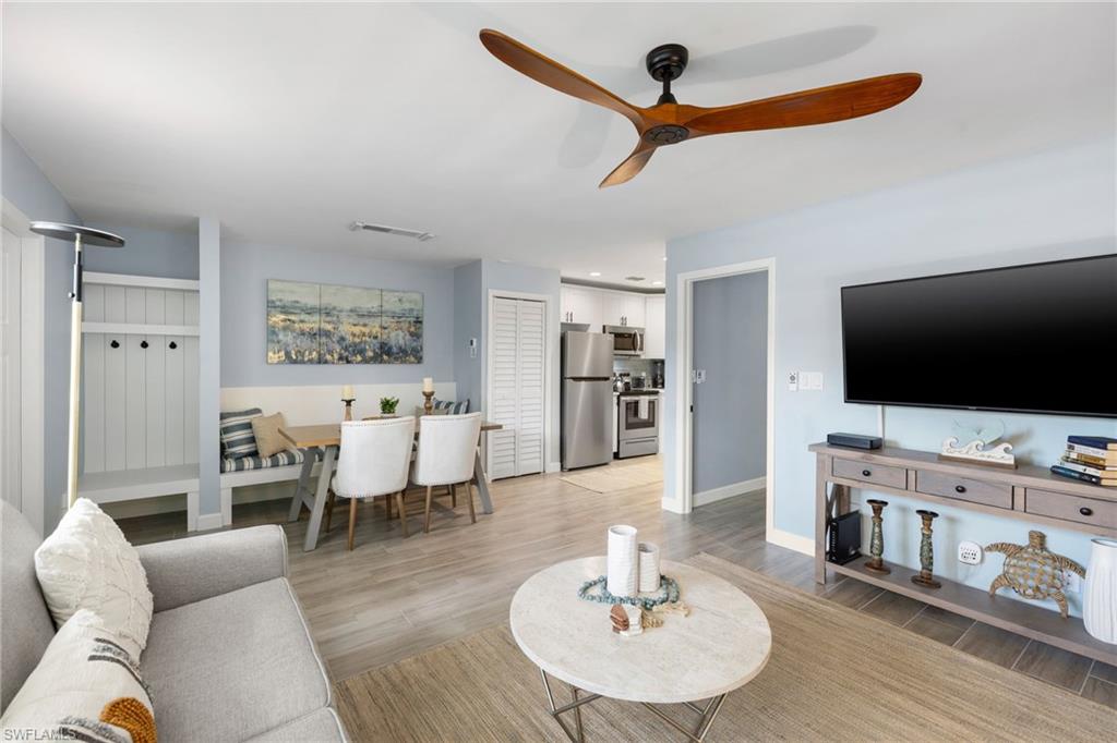 975 9th Avenue South, Unit 19 Naples, FL 34102 - Photo 2 of 19 a living room with furniture and a flat screen tv