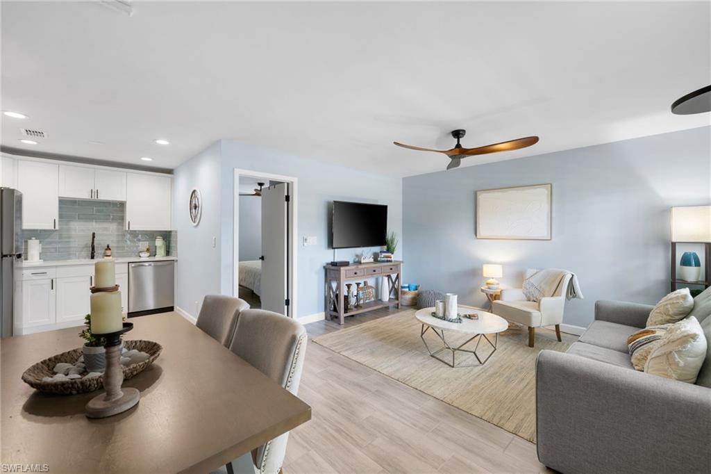 975 9th Avenue South, Unit 19 Naples, FL 34102 - Photo 4 of 19 a living room with furniture kitchen view and a flat screen tv