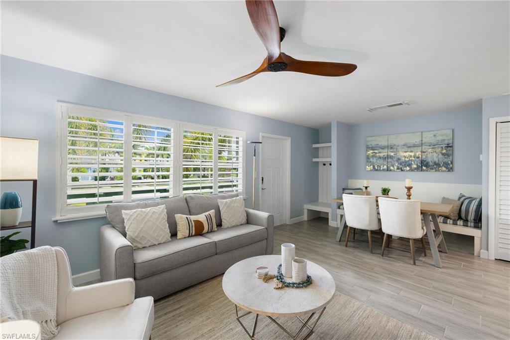 975 9th Avenue South, Unit 19 Naples, FL 34102 - Photo 8 of 19 a living room with furniture and a large window