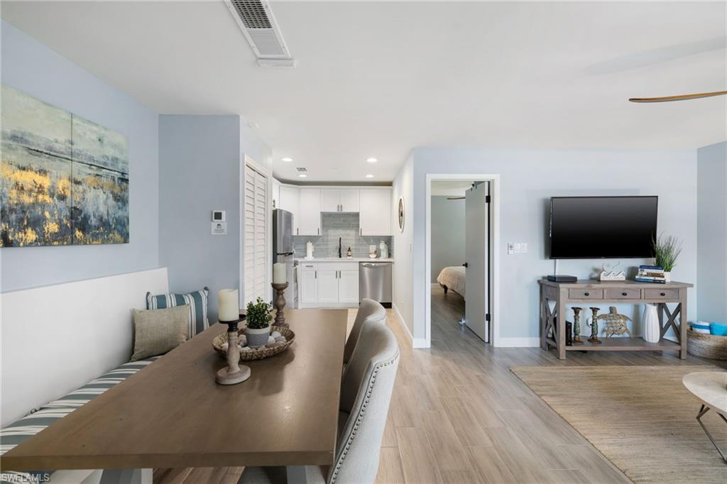 975 9th Avenue South, Unit 19 Naples, FL 34102 - Photo 9 of 19 a living room with furniture and a flat screen tv
