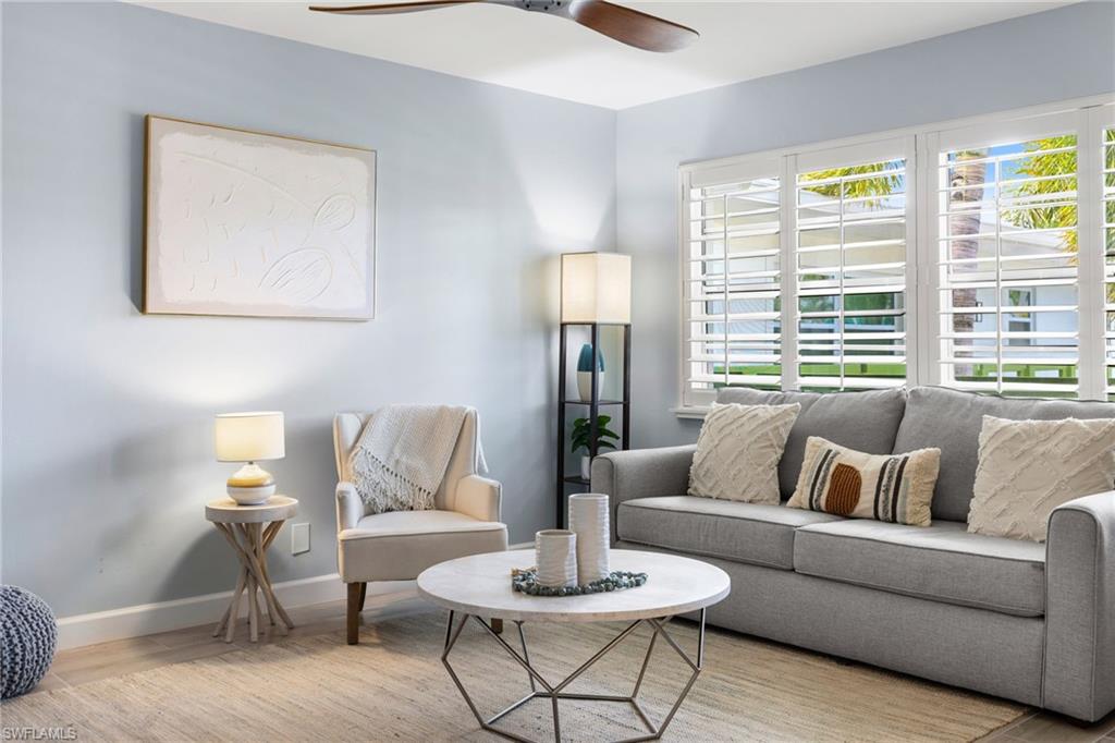 975 9th Avenue South, Unit 19 Naples, FL 34102 - Photo 10 of 19 a living room with furniture and a large window
