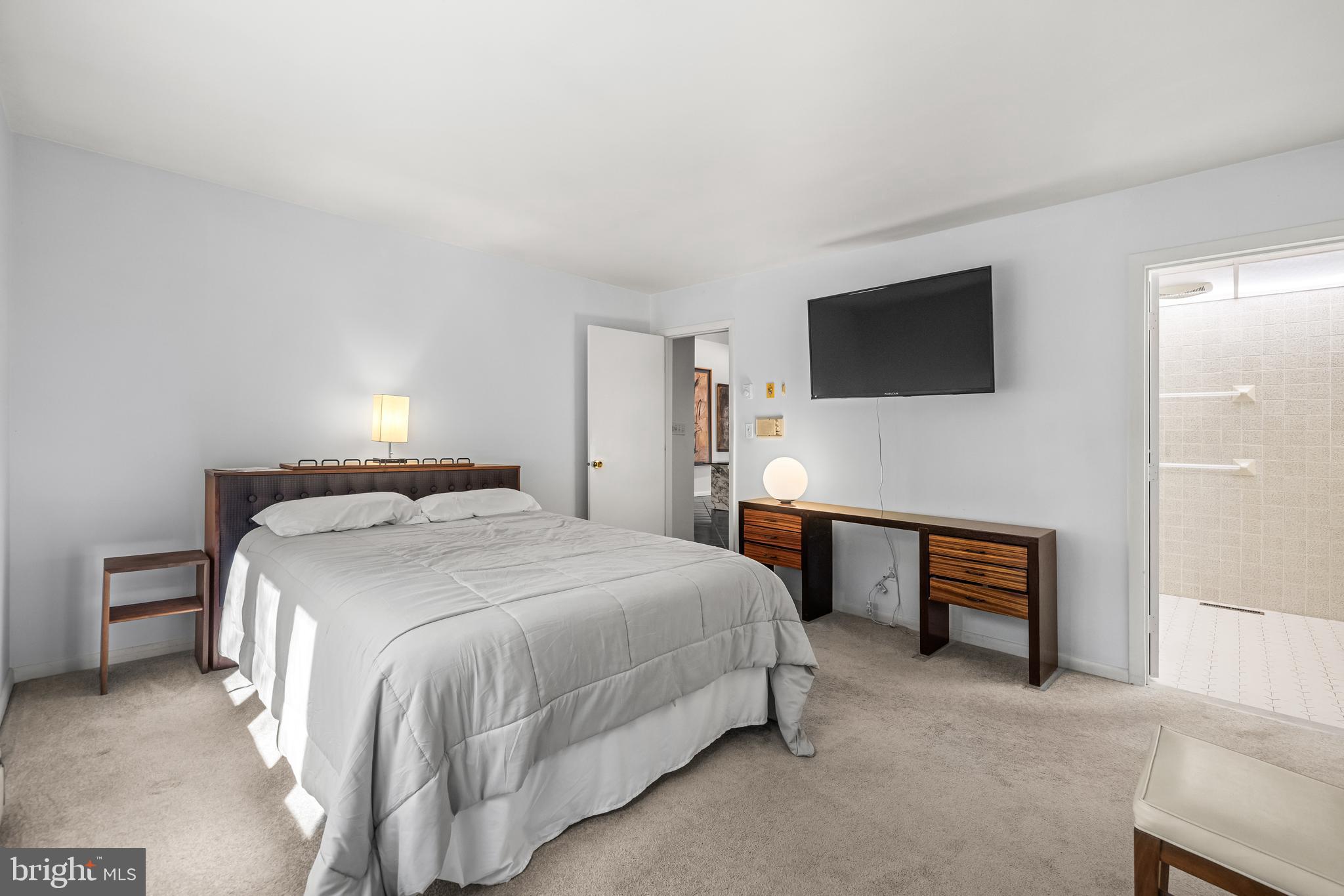 1106 High Country Road Towson, MD 21286 - Photo 34 of 77 a bedroom with a bed and a television