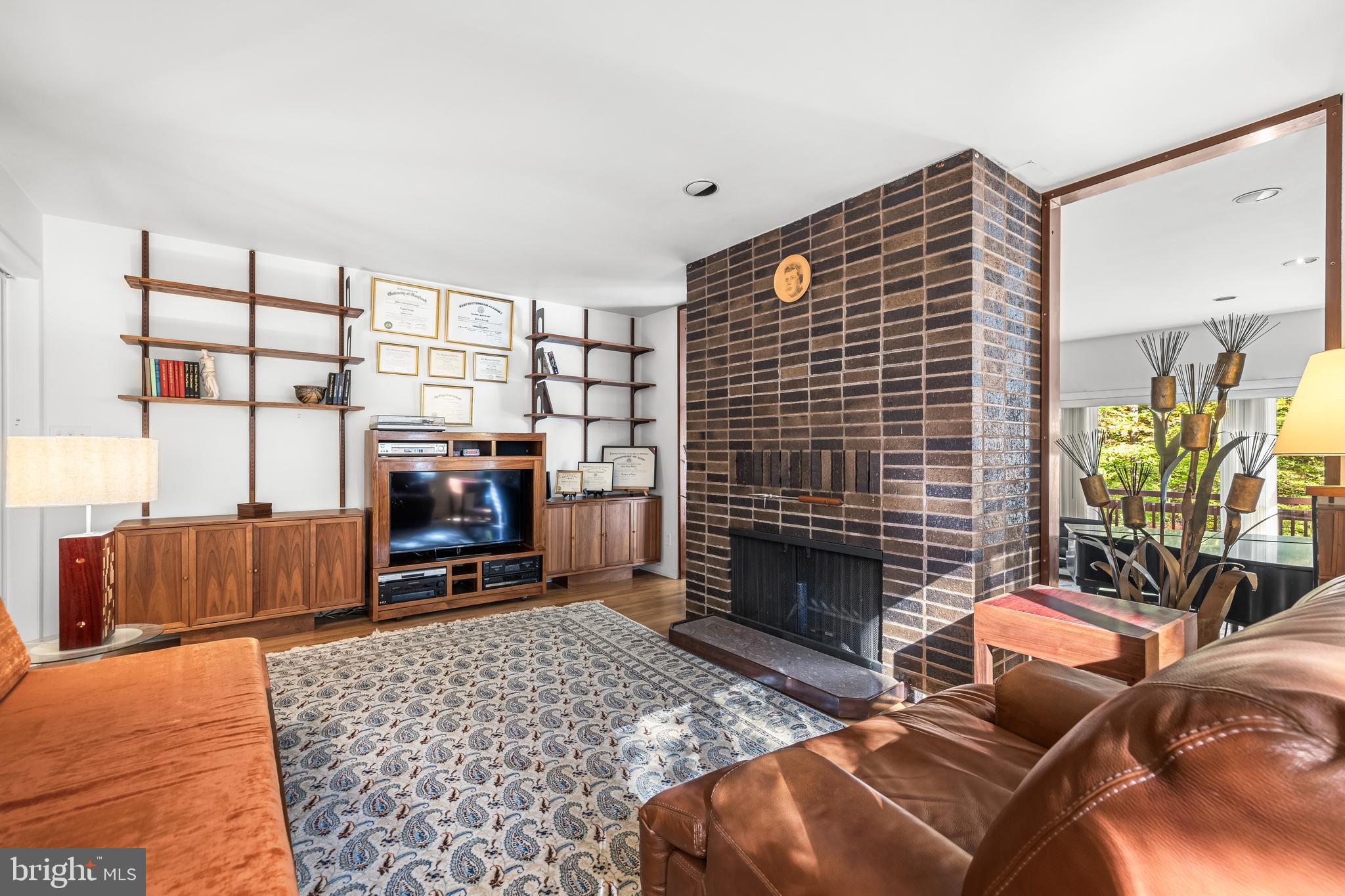 1106 High Country Road Towson, MD 21286 - Photo 38 of 77 a living room with furniture a flat screen tv and a fireplace