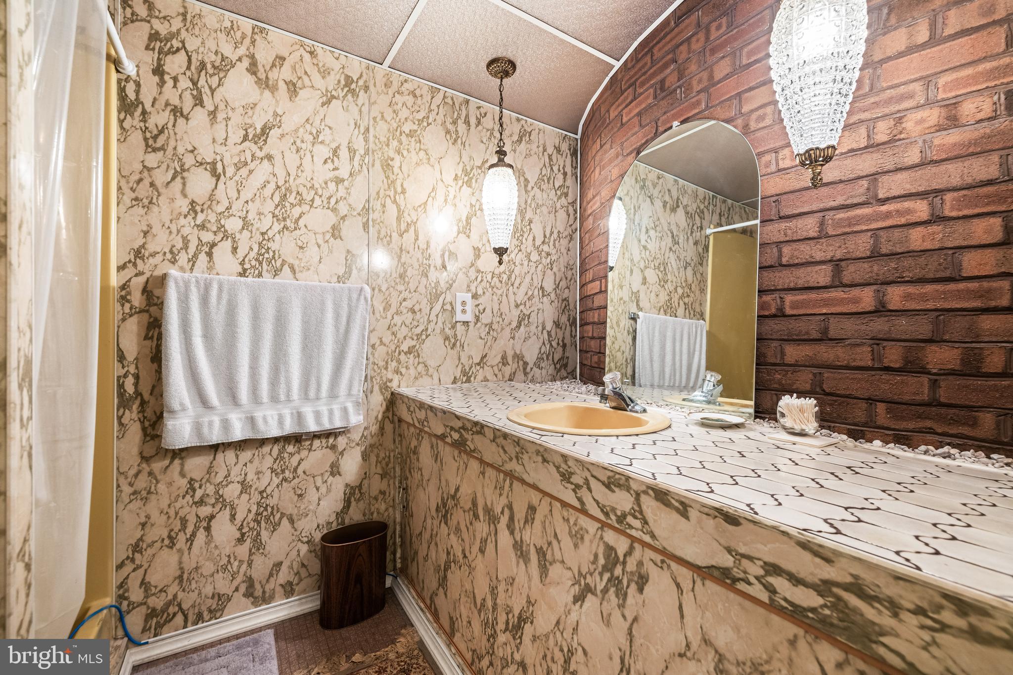 1106 High Country Road Towson, MD 21286 - Photo 73 of 77 a bathroom with a granite countertop sink and a shower