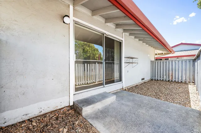 a balcony with furniture and potted plants