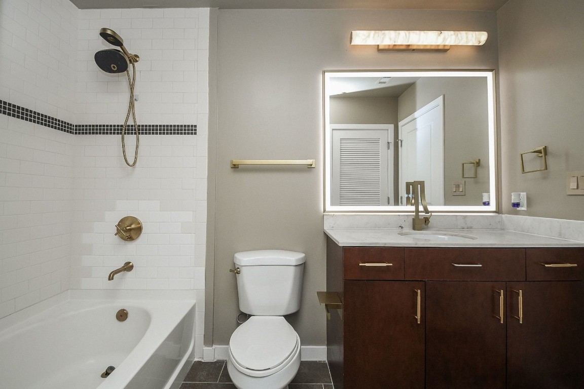 5925 Almeda Road, Unit 10704 Houston, TX 77004 - Photo 14 of 25 En-suite bathroom complete with a large vanity and tub/shower combination.