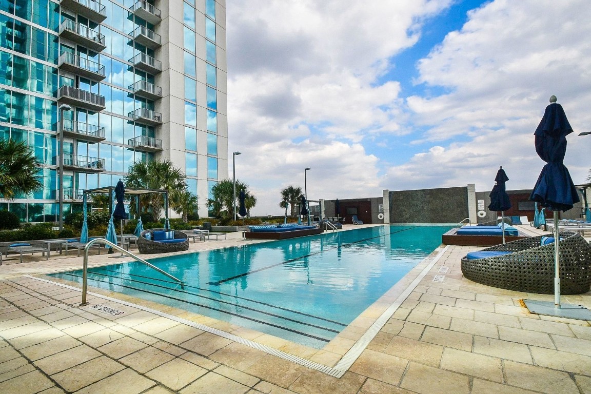 5925 Almeda Road, Unit 10704 Houston, TX 77004 - Photo 22 of 25 Resort-style amenities include a pool deck with cabanas, lounge seating, and panoramic views perfect for relaxing or entertaining in the heart of the city.