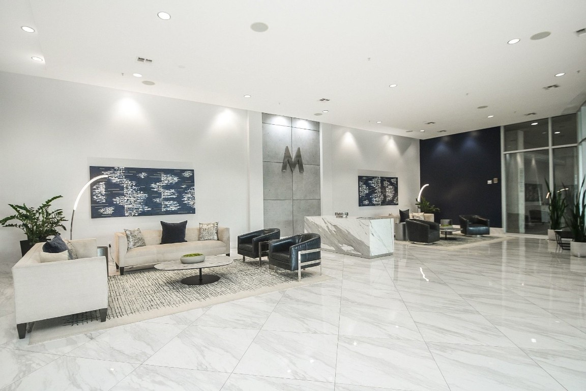 5925 Almeda Road, Unit 10704 Houston, TX 77004 - Photo 24 of 25 Sophisticated lobby welcomes residents and guests with polished marble floors, contemporary lighting, and a 24-hour concierge desk at The Mosaic.