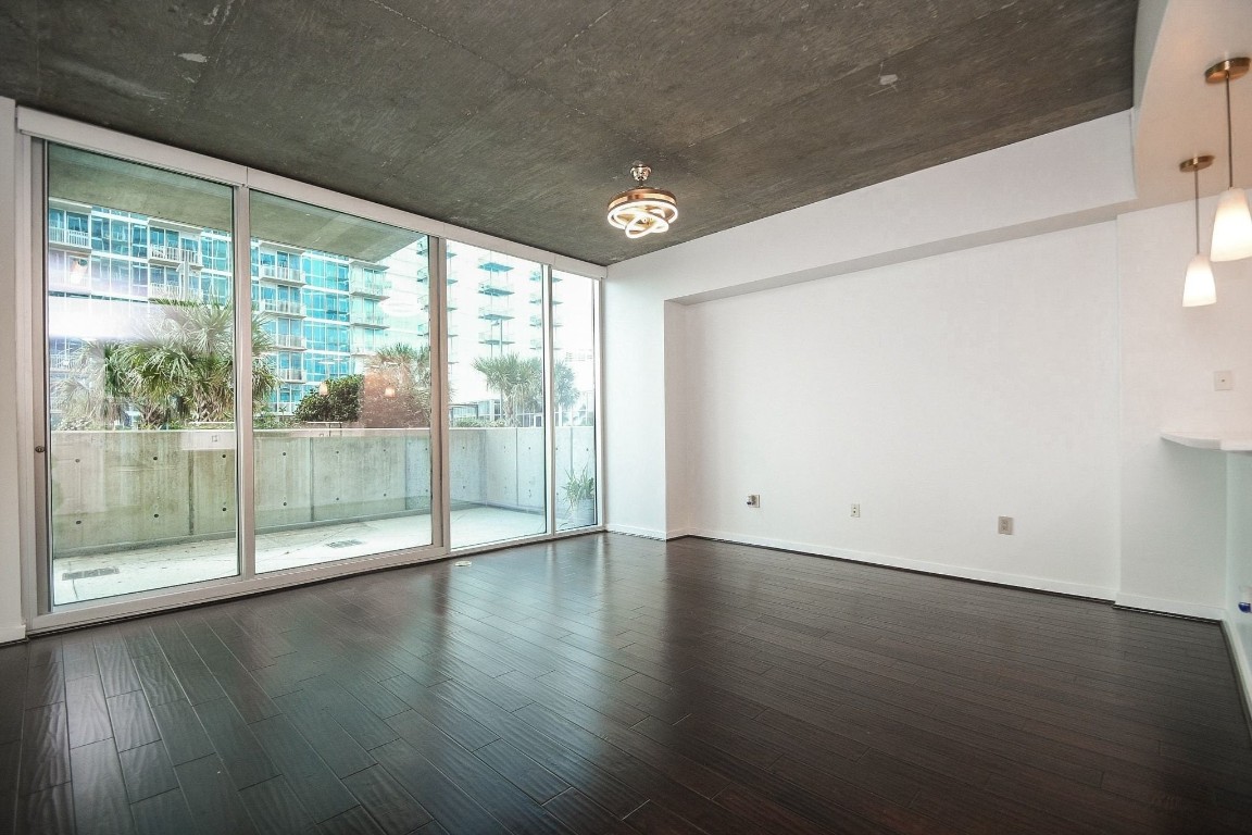 5925 Almeda Road, Unit 10704 Houston, TX 77004 - Photo 3 of 25 Soaring floor-to-ceiling windows fill the open living space with natural light.
