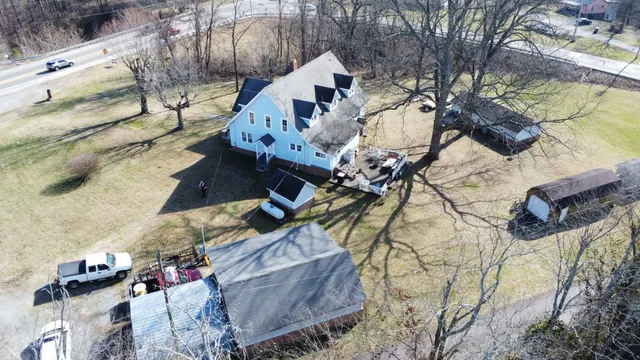 with white house with a yard and wooden fence