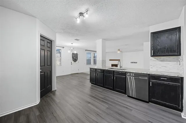 a spacious bathroom with stainless steel appliances granite countertop a sink and a microwave