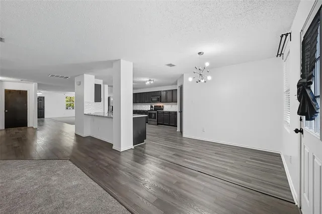 a large kitchen with stainless steel appliances granite countertop a large counter top and sink