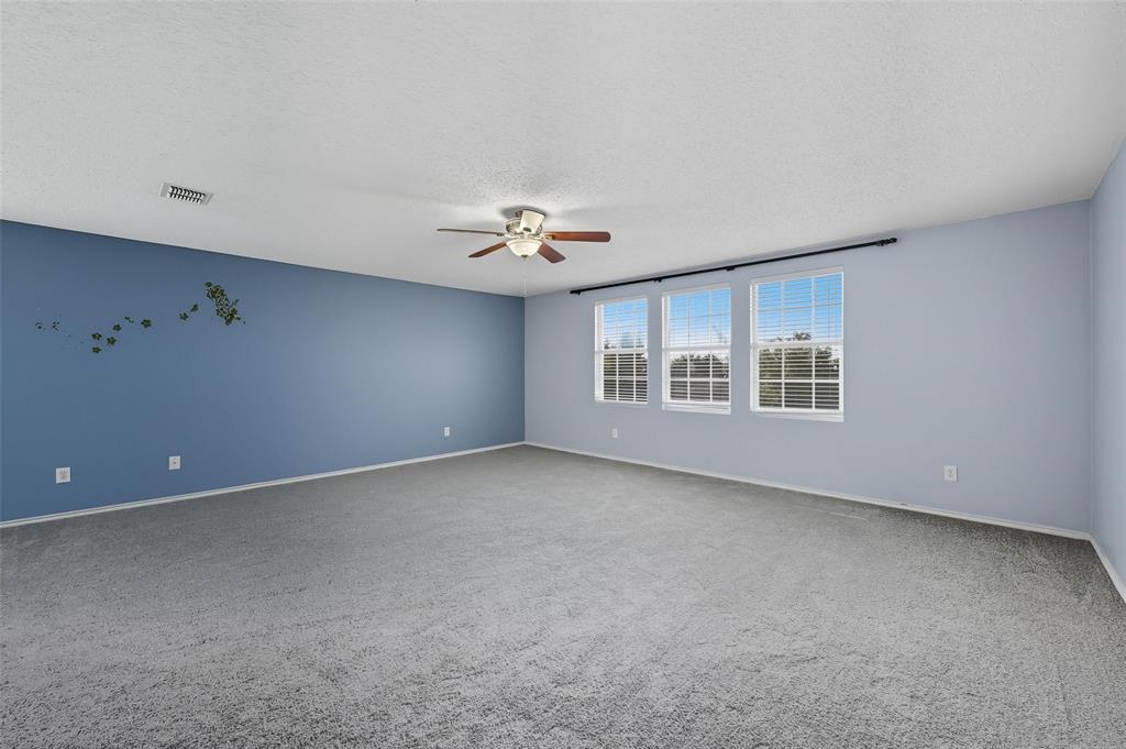 1130 Annie Oakley Drive Anna, TX 75409 - Photo 13 of 32 a view of a livingroom with a ceiling fan and window