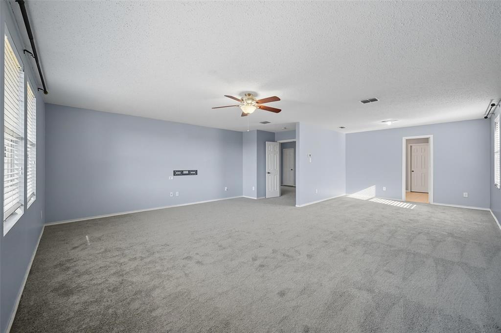 1130 Annie Oakley Drive Anna, TX 75409 - Photo 15 of 32 a view of a livingroom with a ceiling fan and window