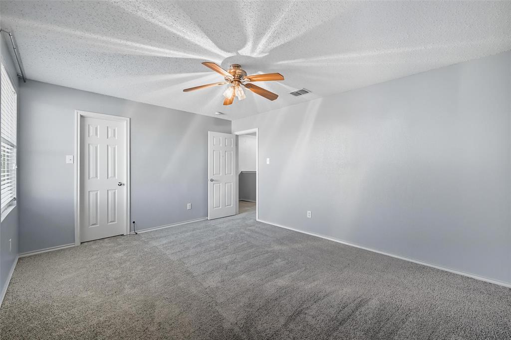 1130 Annie Oakley Drive Anna, TX 75409 - Photo 21 of 32 an empty room with windows and fan