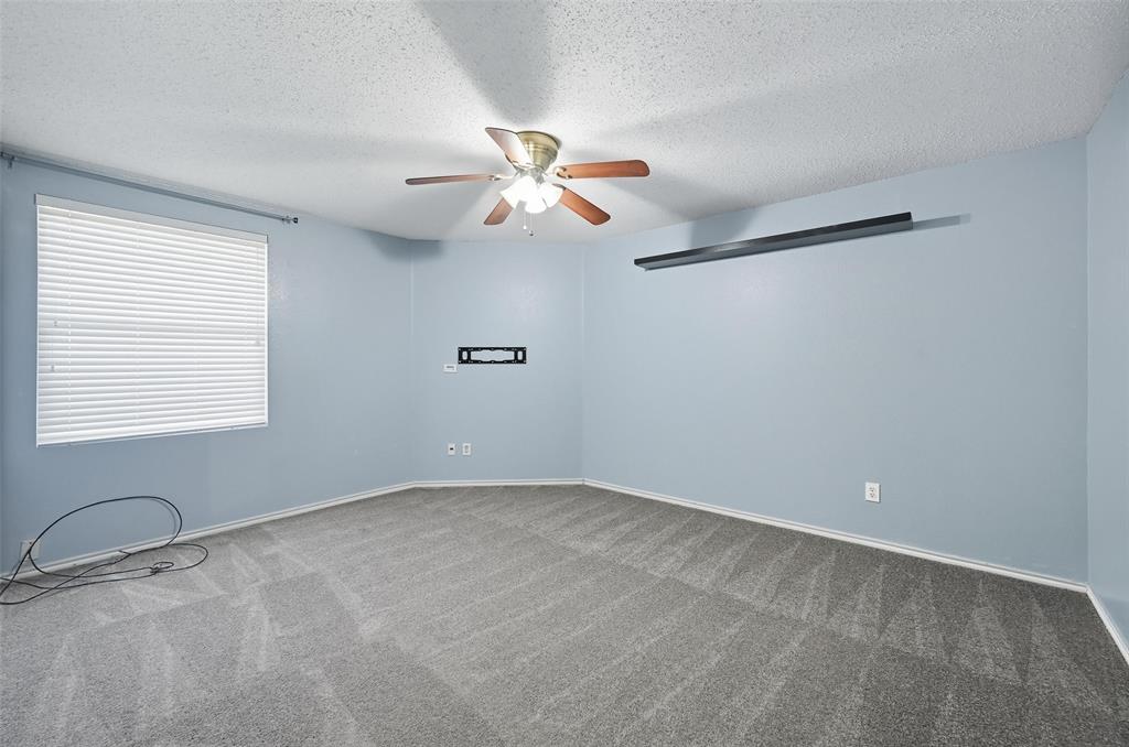 1130 Annie Oakley Drive Anna, TX 75409 - Photo 23 of 32 an empty room with windows and fan