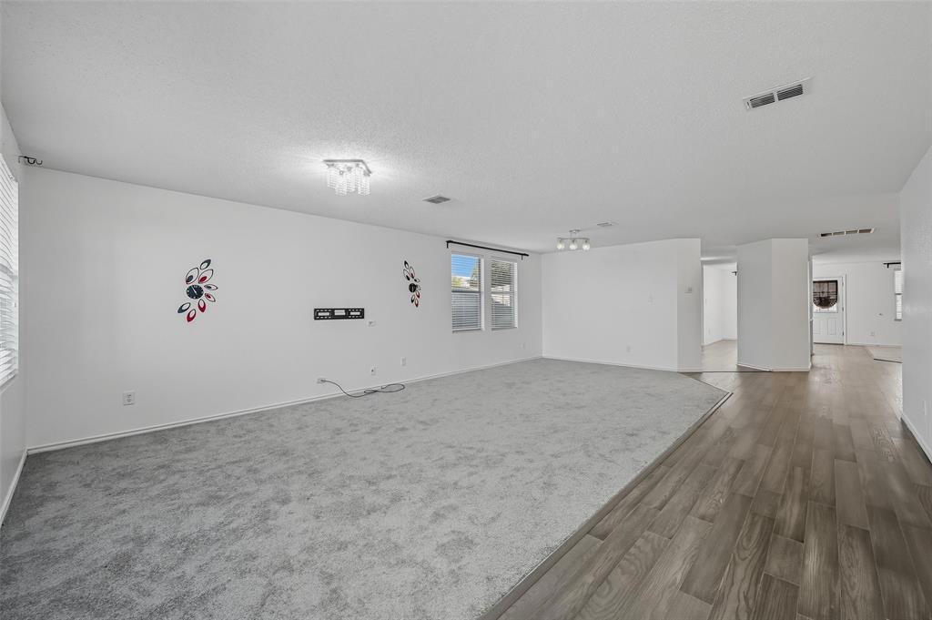 1130 Annie Oakley Drive Anna, TX 75409 - Photo 4 of 32 a view of empty room with wooden floor