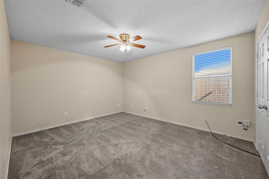 1130 Annie Oakley Drive Anna, TX 75409 - Photo 7 of 32 an empty room with windows and chandelier fan
