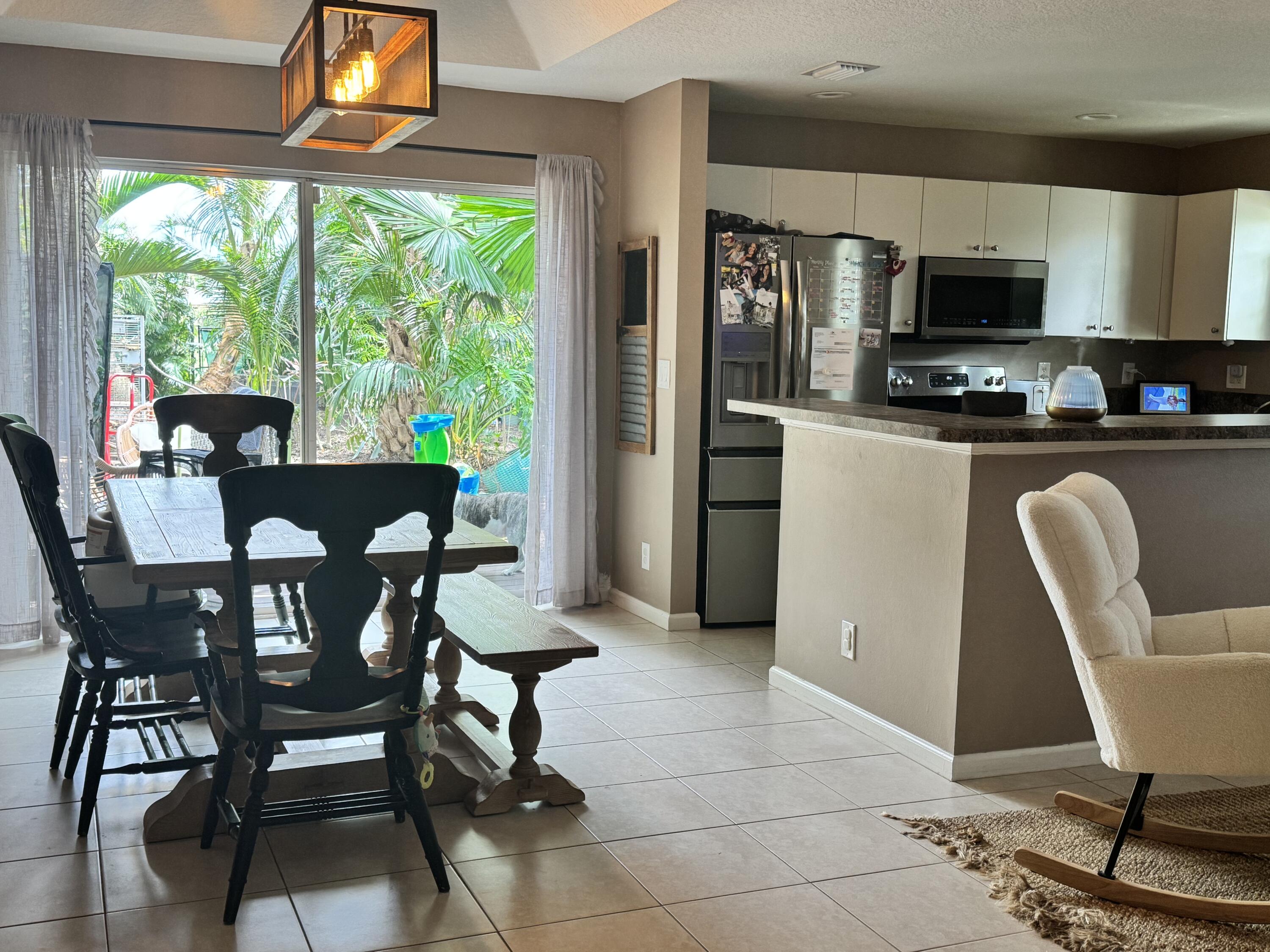 4571 Southeast Murray Cove Circle Stuart, FL 34997 - Photo 15 of 35 a dining room with furniture and window