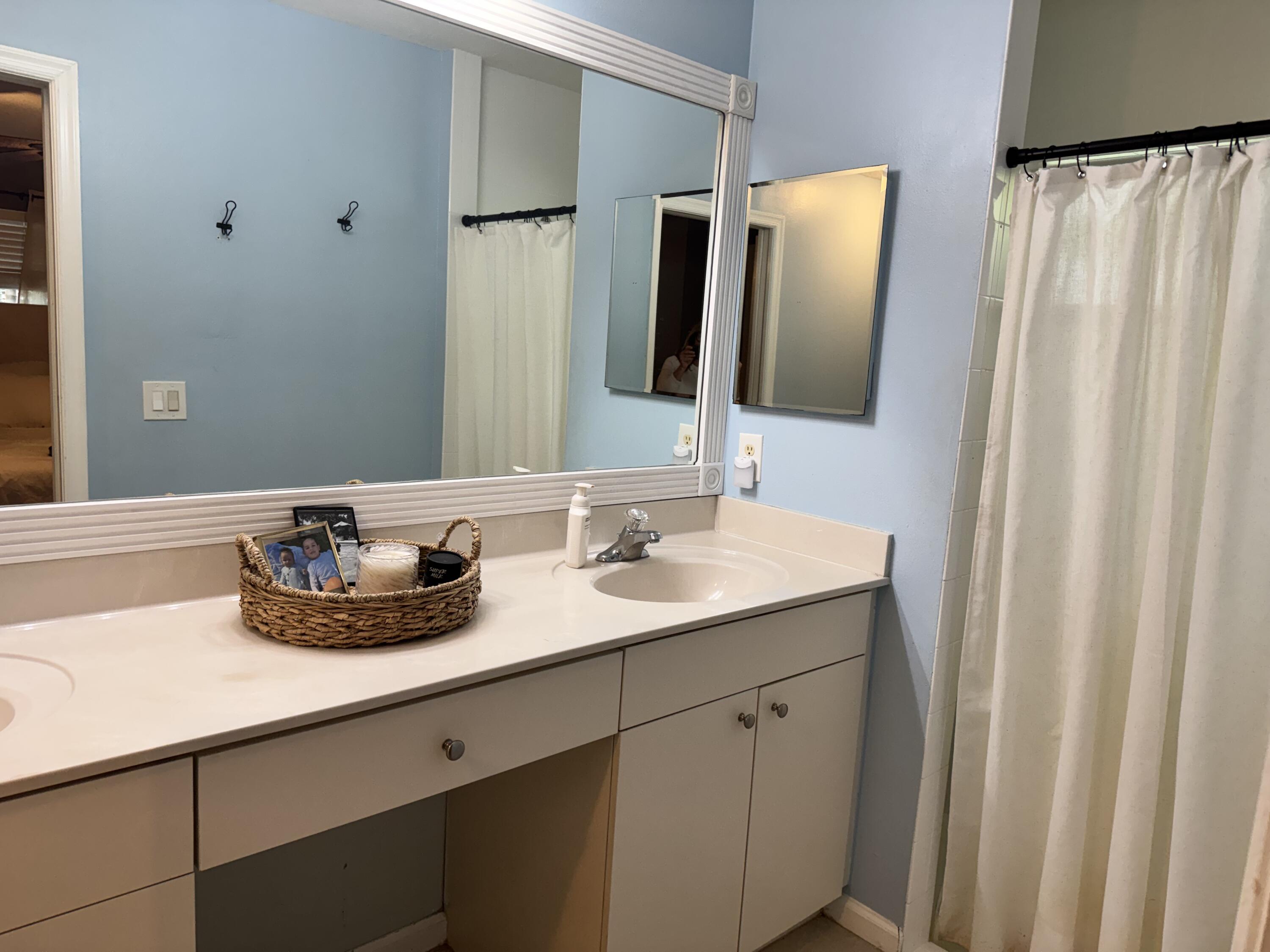 4571 Southeast Murray Cove Circle Stuart, FL 34997 - Photo 22 of 35 a bathroom with a double vanity sink and a mirror