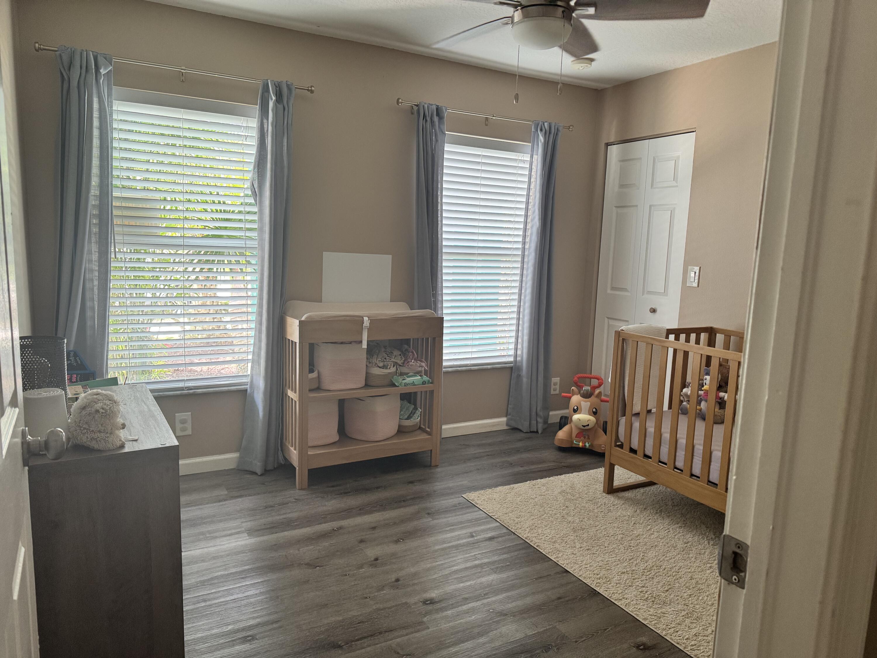 4571 Southeast Murray Cove Circle Stuart, FL 34997 - Photo 25 of 35 a living room with furniture and wooden floor