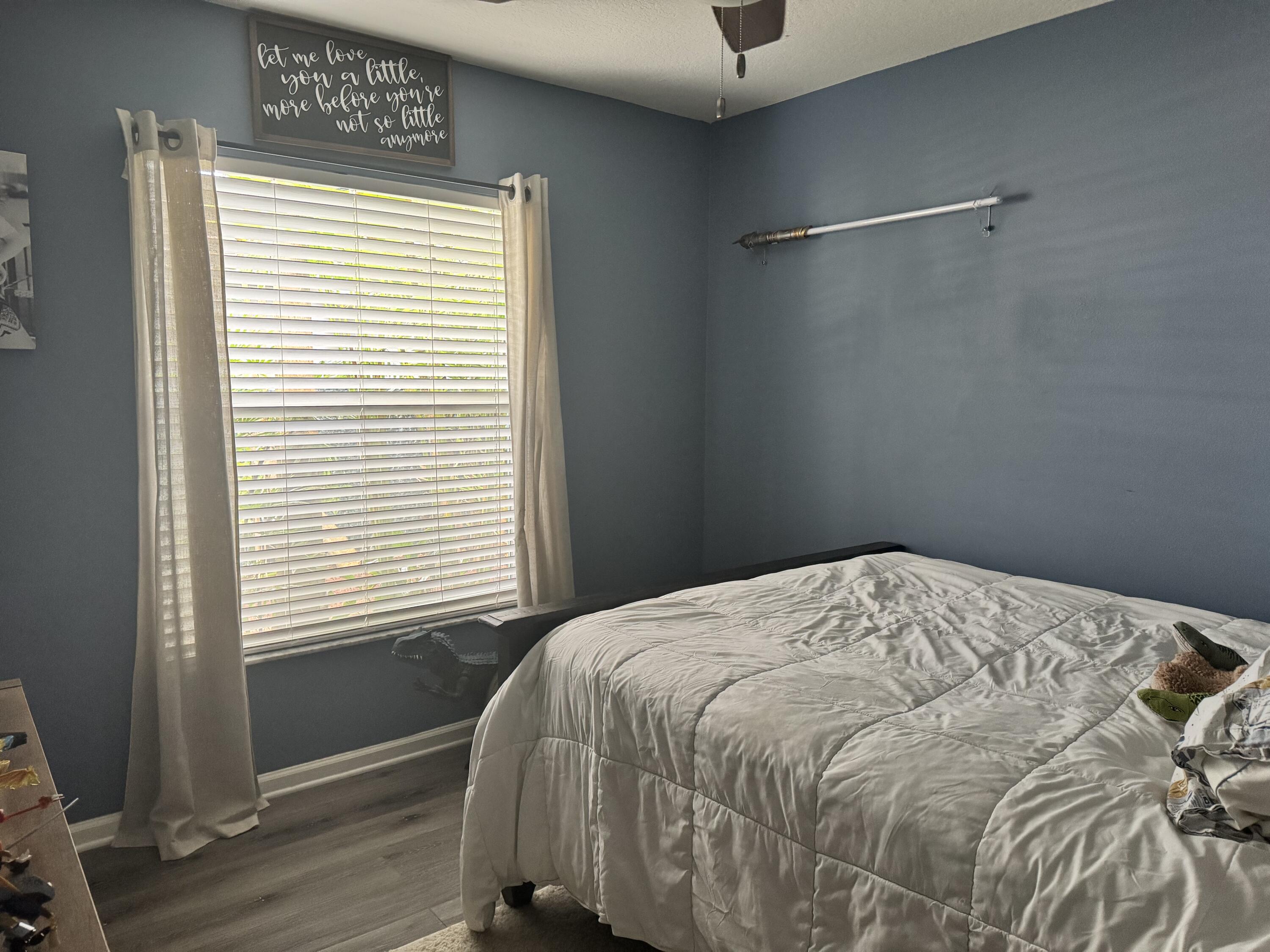 4571 Southeast Murray Cove Circle Stuart, FL 34997 - Photo 28 of 35 a bedroom with a bed and a window