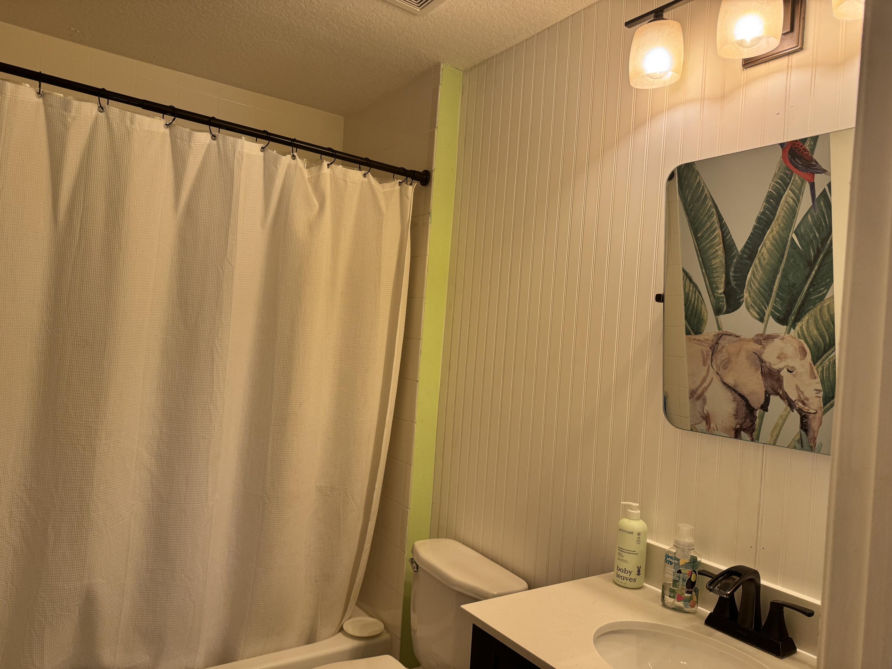 4571 Southeast Murray Cove Circle Stuart, FL 34997 - Photo 33 of 35 a bathroom with a sink and a mirror