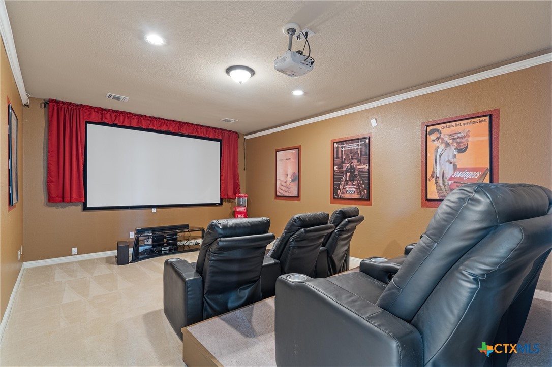 a living room with furniture and wall paintings