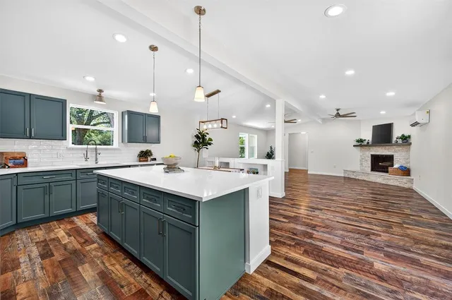 a kitchen with a sink stove and microwave
