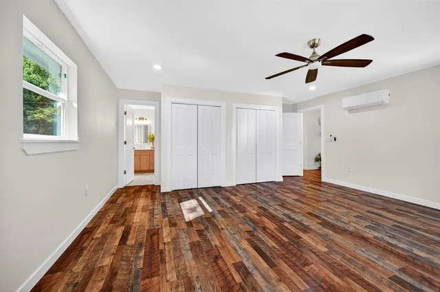 a bathroom with double sink a toilet and a mirror