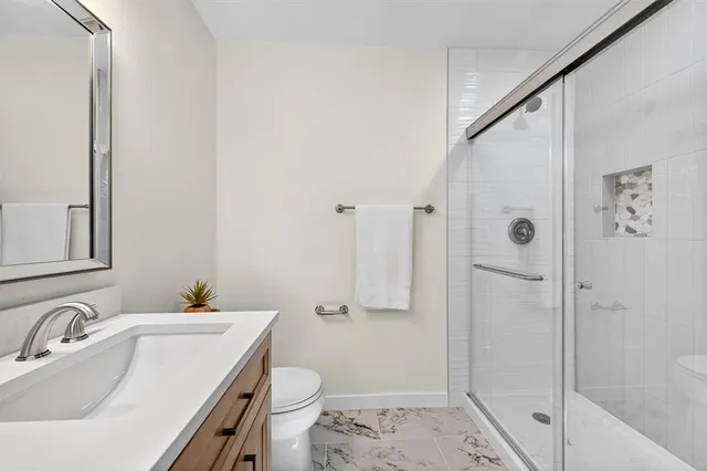 an empty room with windows and ceiling fan