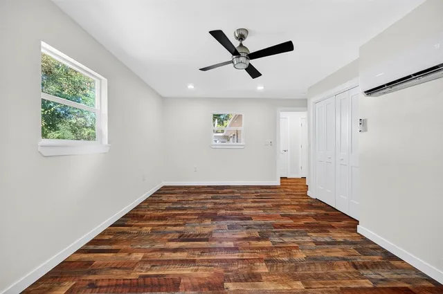 a view of empty room with wooden floor