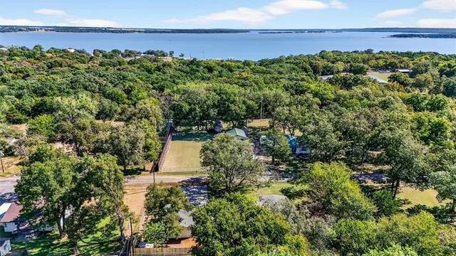 an aerial view of a houses with a yard