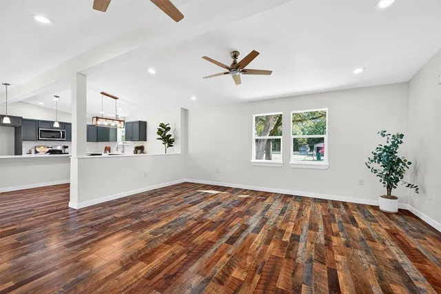 a view of a kitchen with wooden floor and a kitchen