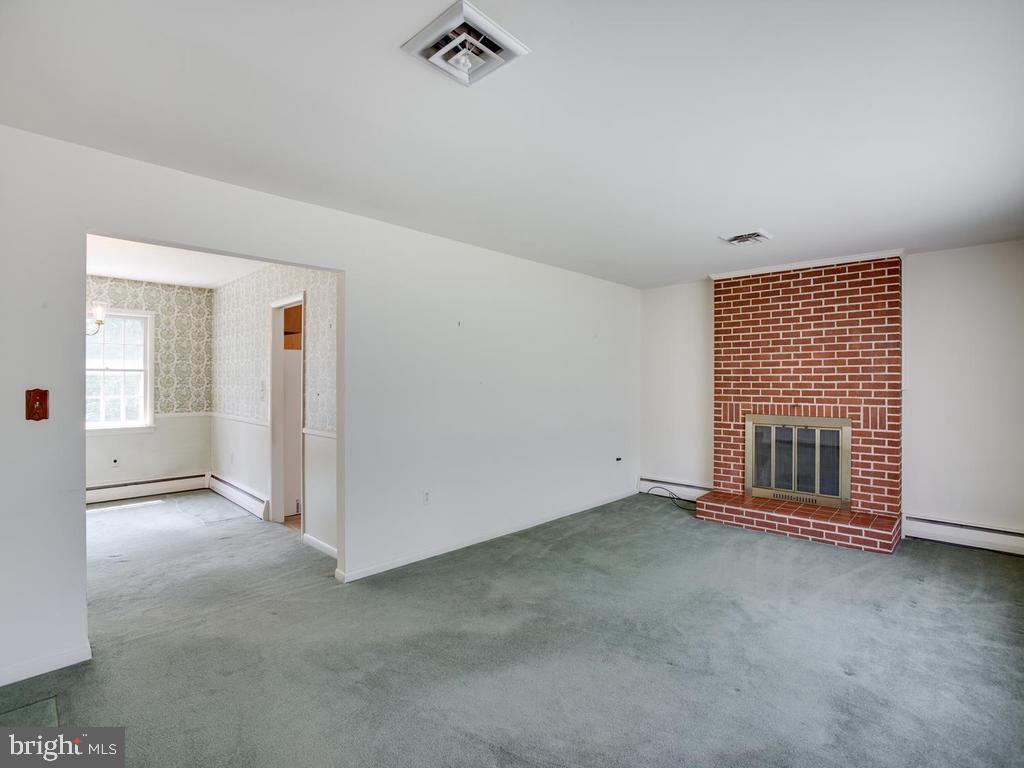 301 Plum Point Road Huntingtown, MD 20639 - Photo 5 of 17 Living room with fireplace