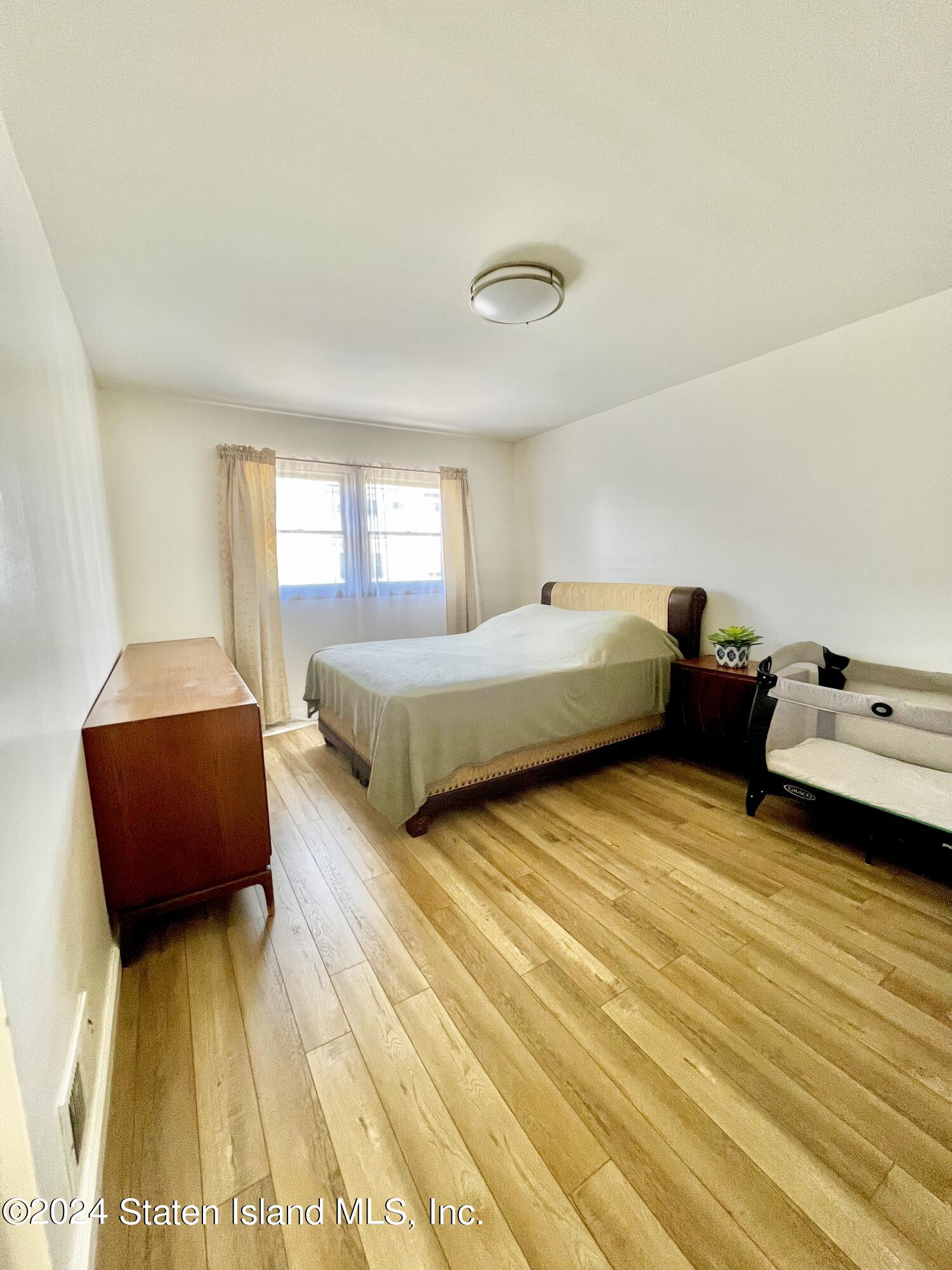 4 Futurity Place Staten Island, NY 10312 - Photo 13 of 26 a bedroom with two beds and a couch