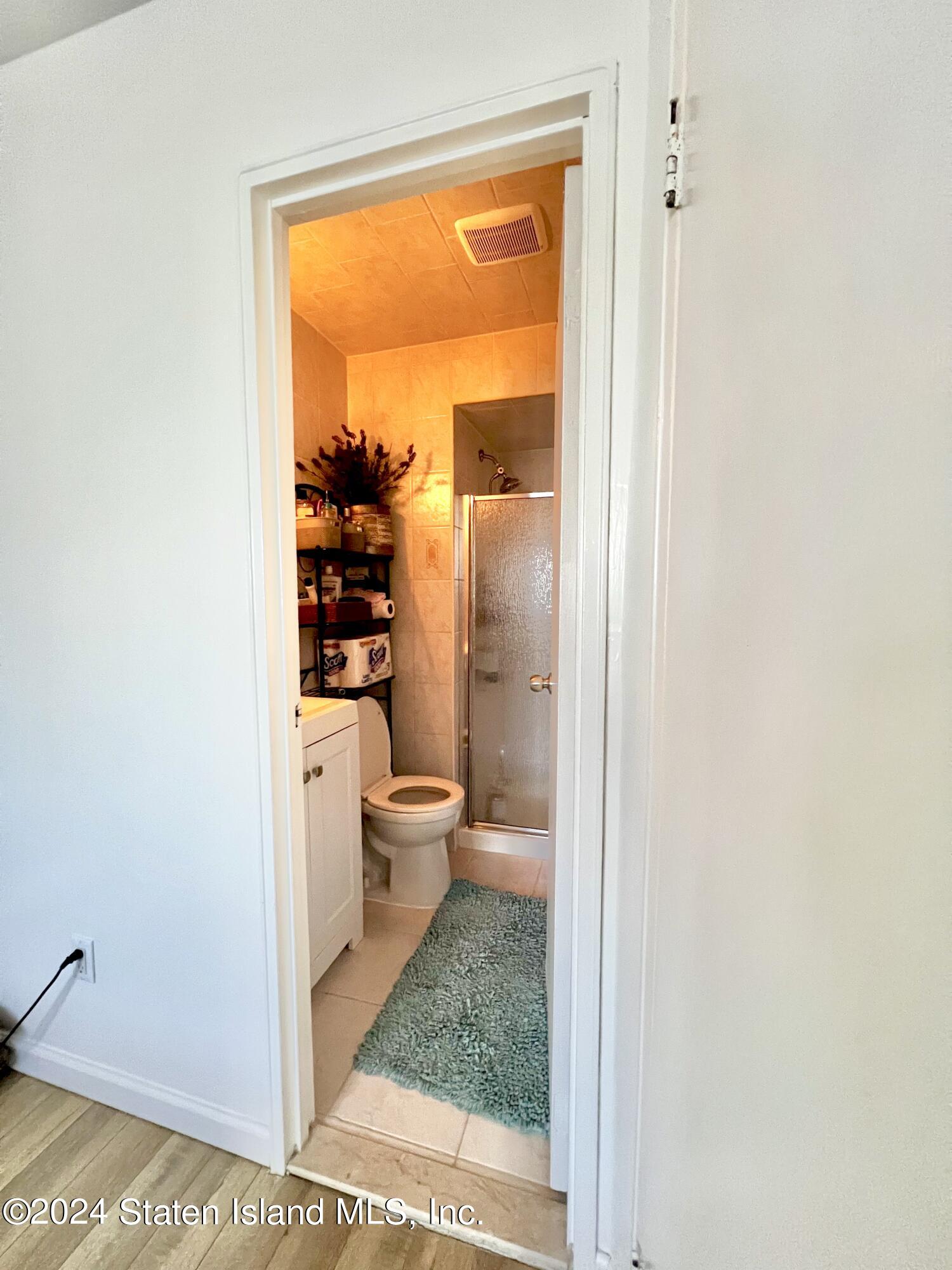 4 Futurity Place Staten Island, NY 10312 - Photo 14 of 26 a bathroom with a toilet a sink and shower