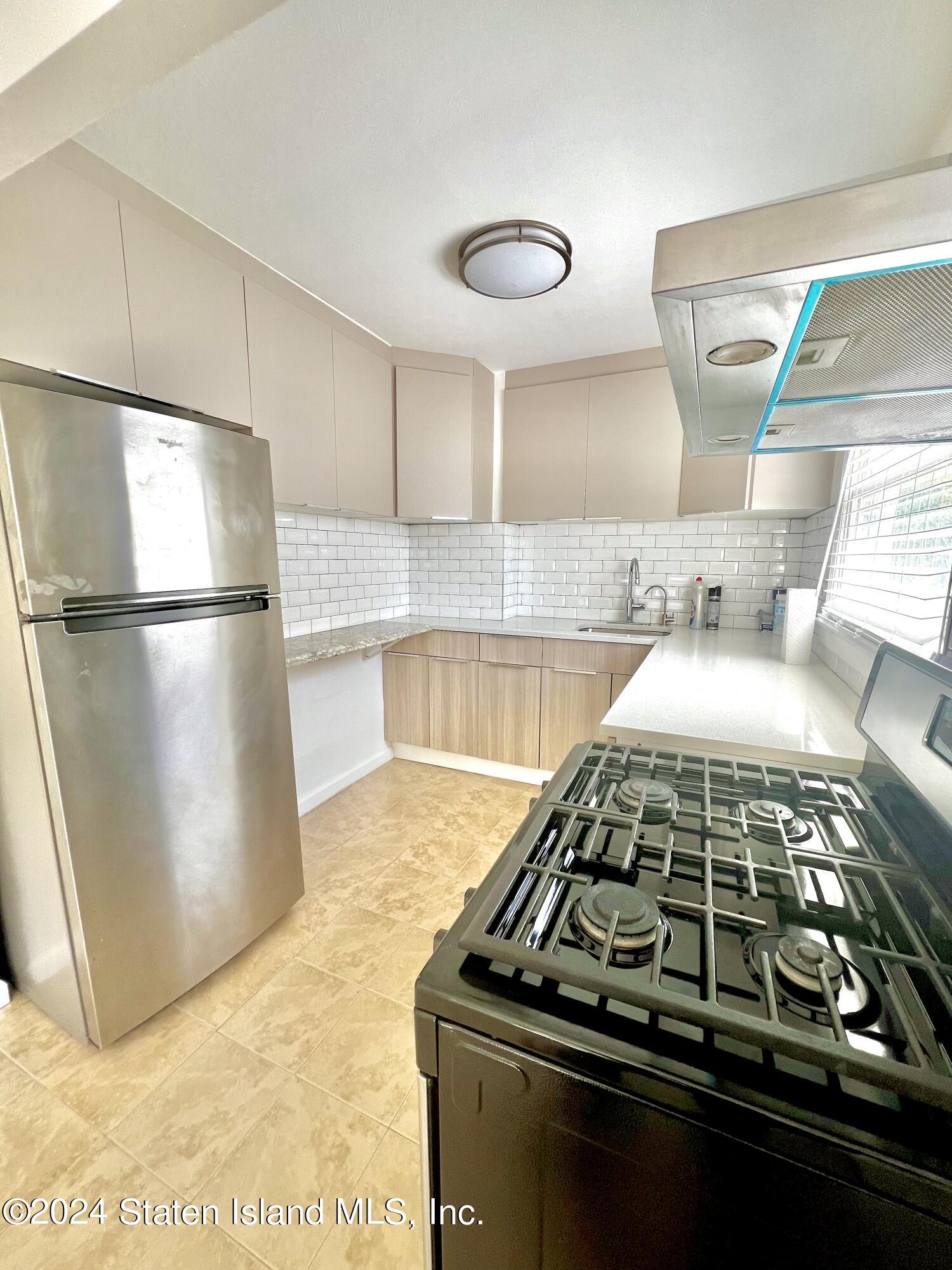 4 Futurity Place Staten Island, NY 10312 - Photo 22 of 26 a kitchen with a stove and a refrigerator