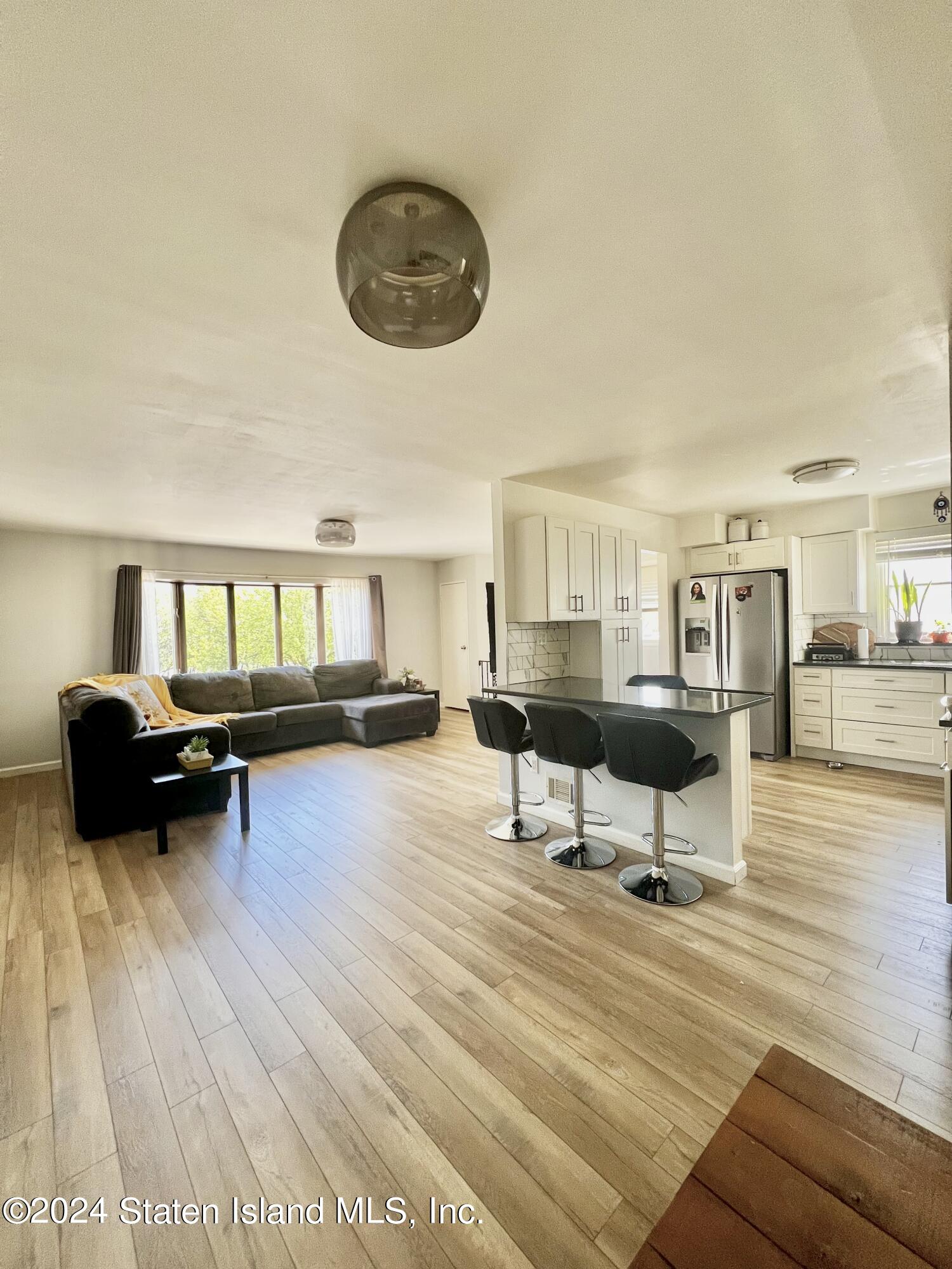4 Futurity Place Staten Island, NY 10312 - Photo 4 of 26 a living room with furniture and a wooden floor