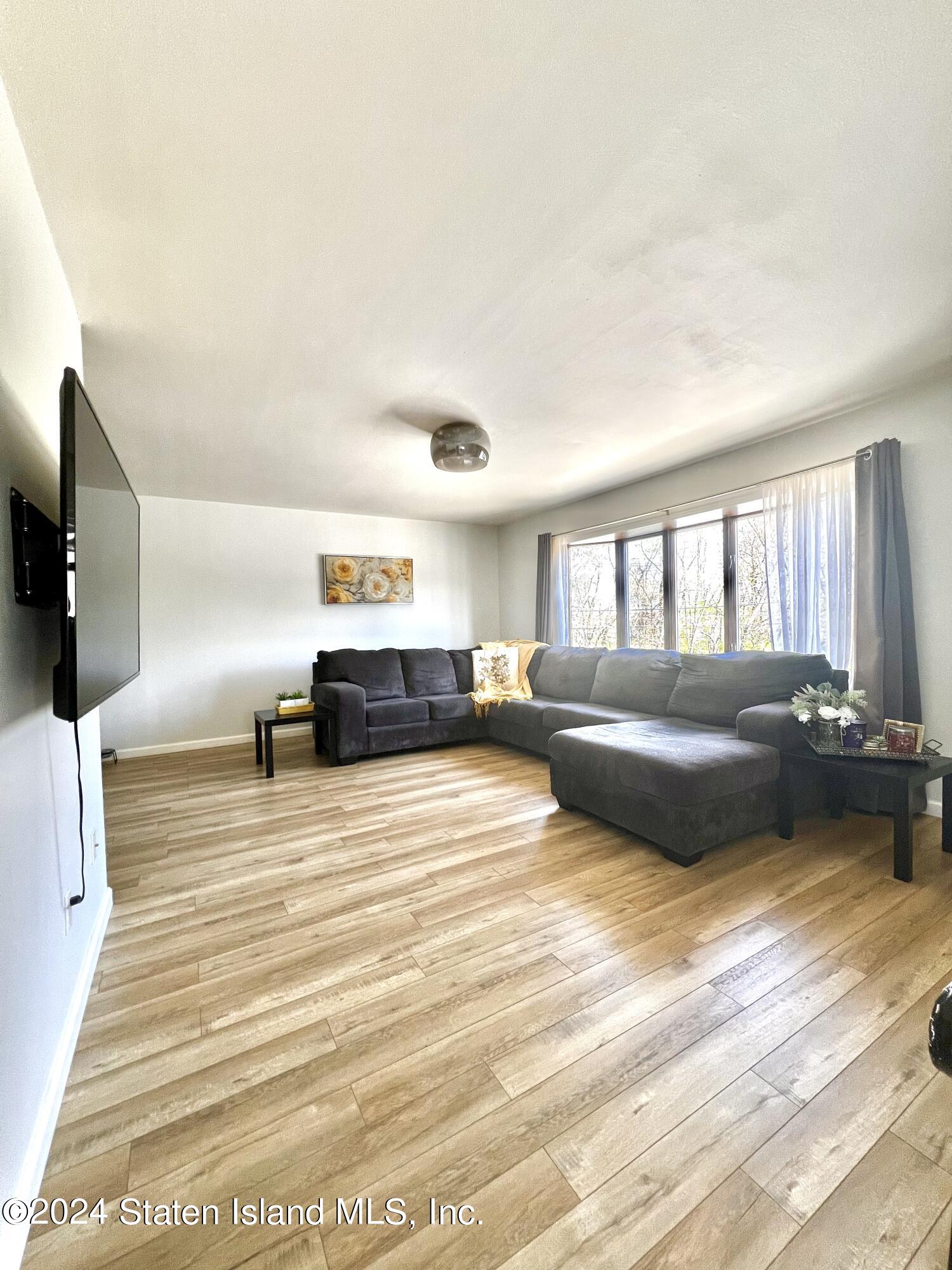 4 Futurity Place Staten Island, NY 10312 - Photo 5 of 26 a living room with furniture and a flat screen tv