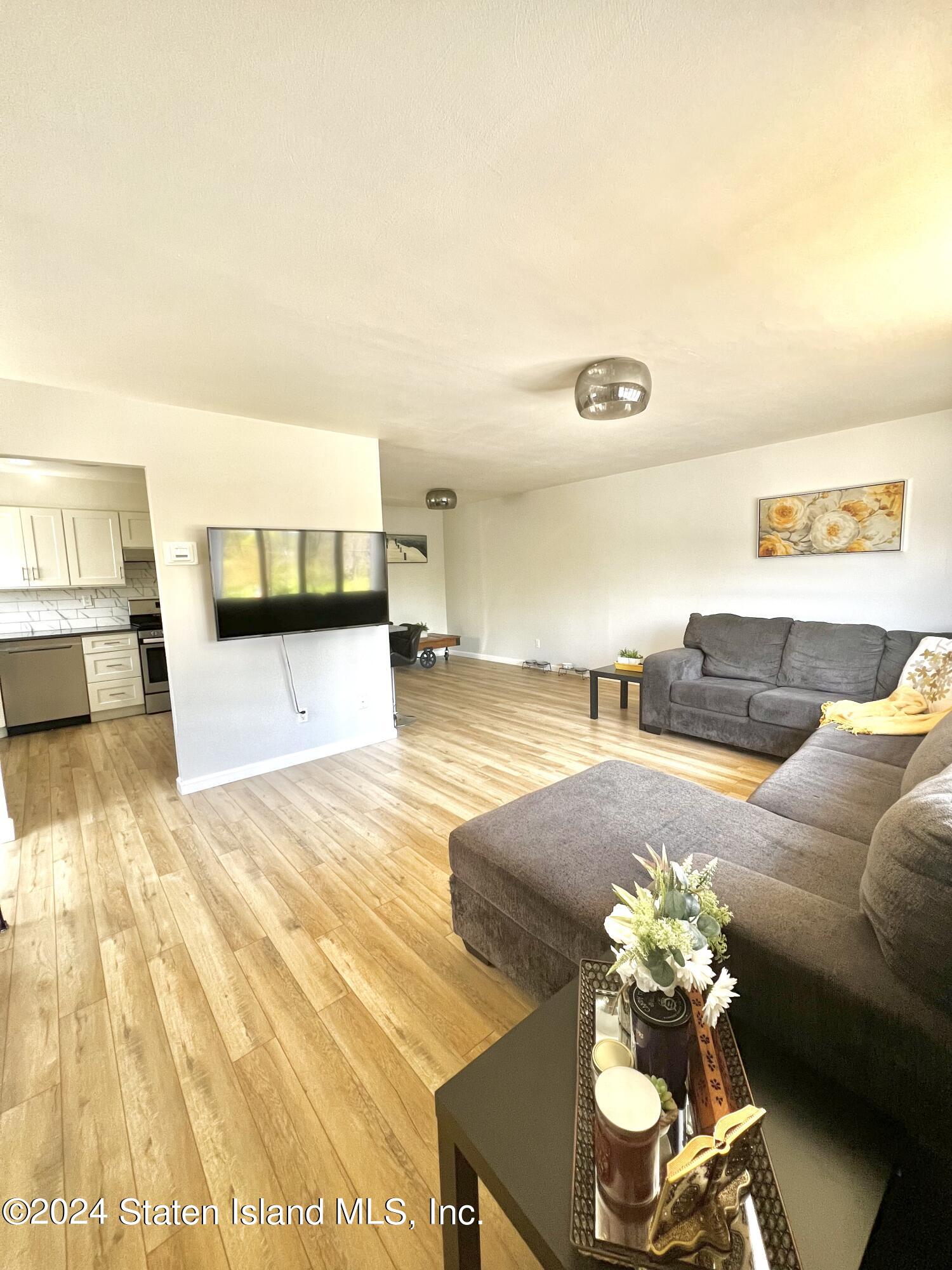 4 Futurity Place Staten Island, NY 10312 - Photo 6 of 26 a living room with furniture and wooden floor
