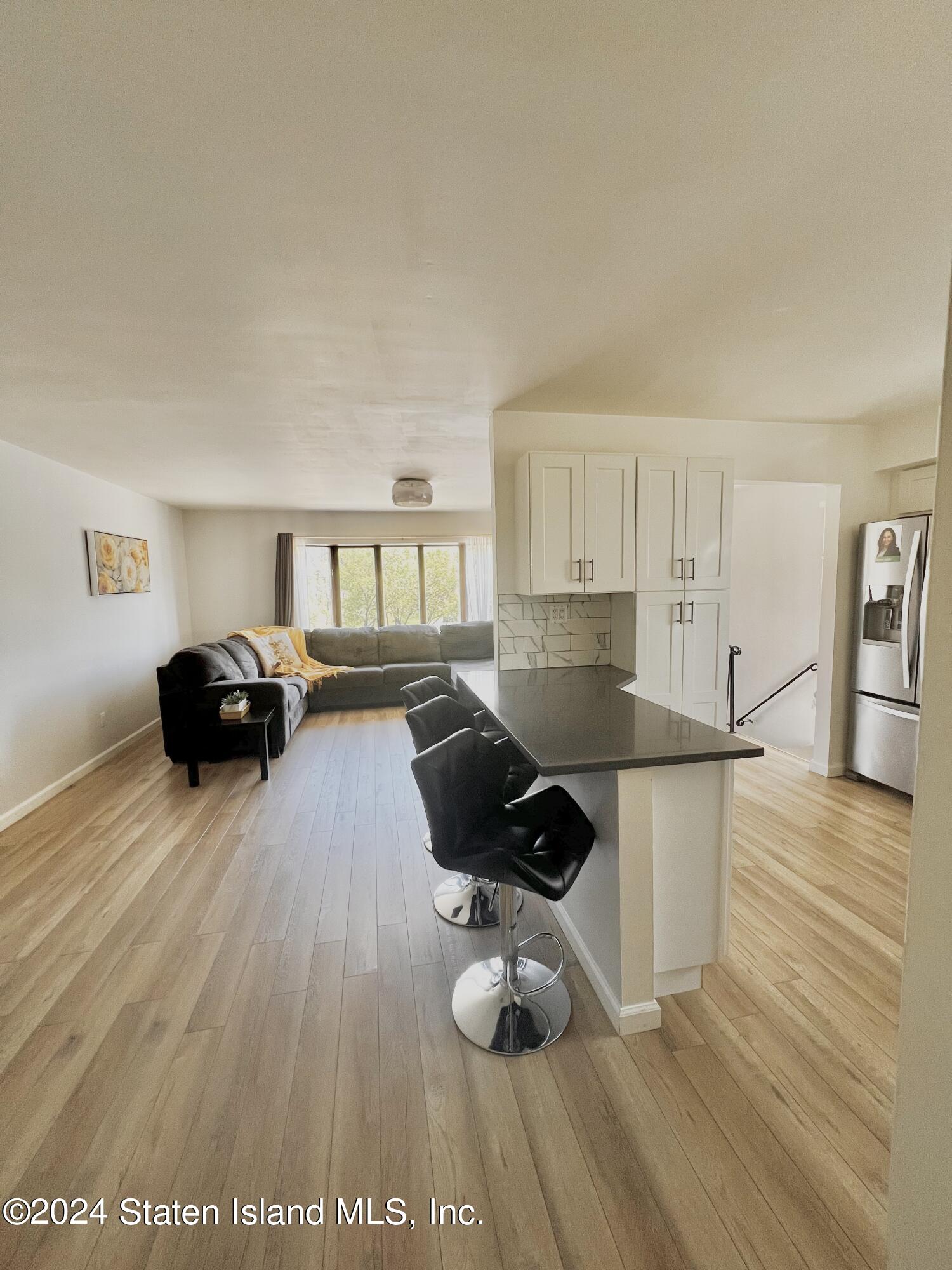4 Futurity Place Staten Island, NY 10312 - Photo 7 of 26 a living room with furniture and a wooden floor