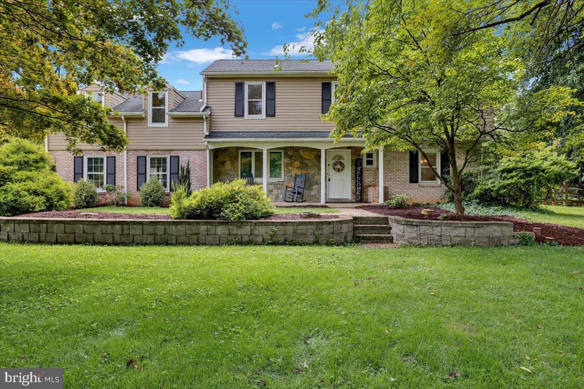 a front view of house with yard and green space