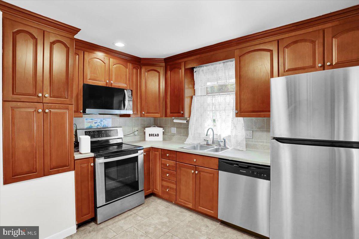 416 Green Lane Reading, PA 19601 - Photo 11 of 42 a kitchen with stainless steel appliances granite countertop a refrigerator stove microwave and sink