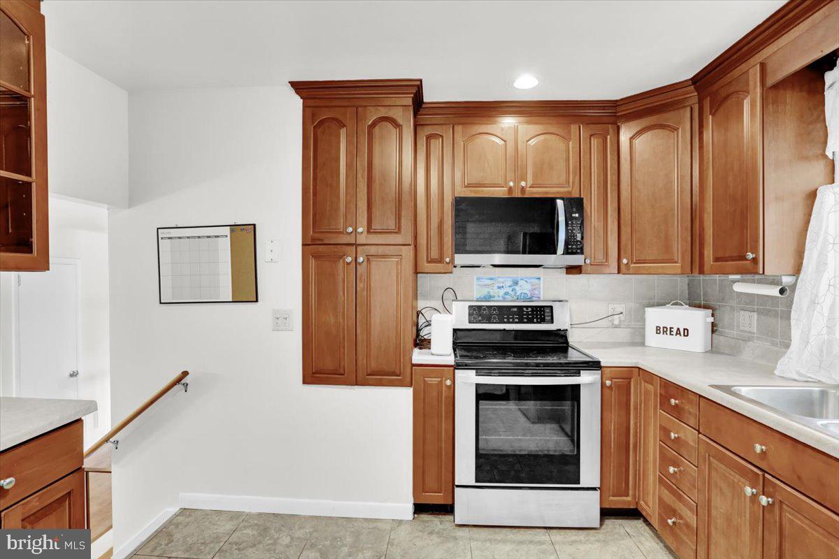 416 Green Lane Reading, PA 19601 - Photo 12 of 42 a kitchen with a stove and a microwave
